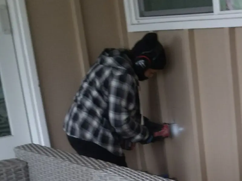 Professional electrician installing an exterior outlet in Forest Lake